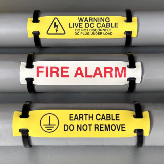 Three warning labels on a cable with text and symbols.